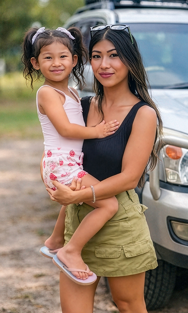 A parent fastening a child into a car seat